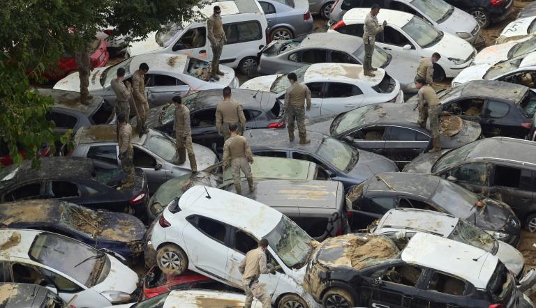 Veteranos buscan coches destrozados por las inundaciones en Massassana, región de Valencia.