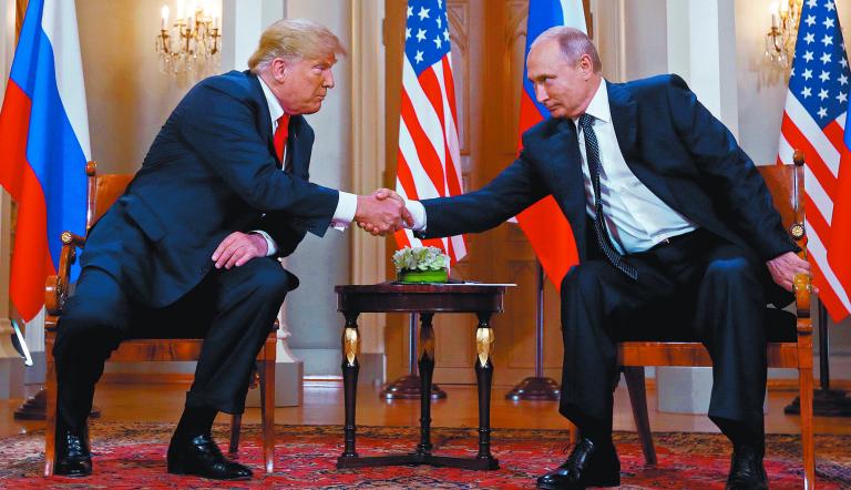 U.S. President Donald Trump and Russia's President Vladimir Putin shake hands as they meet in Helsinki, Finland July 16, 2018. REUTERS/Kevin Lamarque TPX IMAGES OF THE DAY
