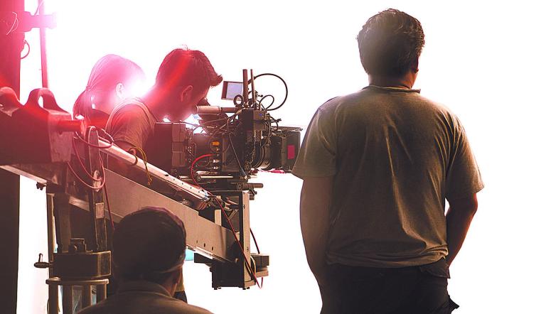 Behind the scenes of video shooting production crew team and professional camera equipment in studio.
