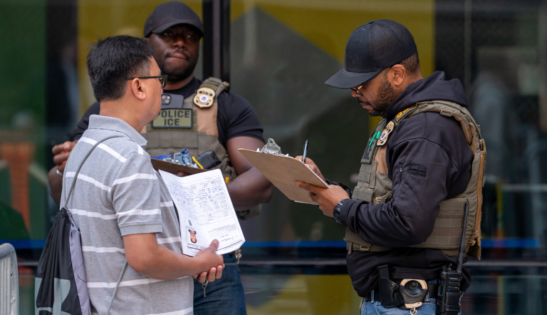 Un agente de ICE interroga a un migrante.