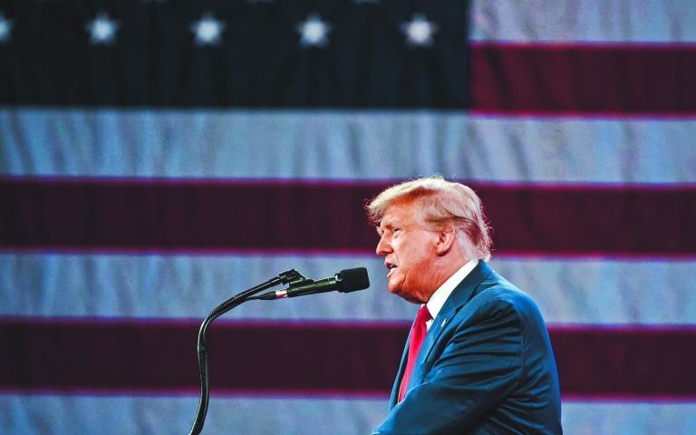 NATIONAL HARBOR, MD, USA- February 24, 2024: Donald Trump speaks at an event about his plan for defeating current President Joe Biden in November.