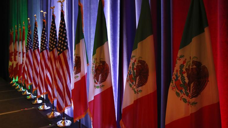 FILE - In this Aug. 16, 2017 file photo, the national flags of Canada, from left, the U.S. and Mexico, are lit by stage lights before a news conference, at the start of North American Free Trade Agreement renegotiations in Washington D.C. Mexico appears to be preparing for the worst as the fourth round of talks open in Washington D.C, Wednesday, Oct. 11, 2017.  (AP Photo/Jacquelyn Martin, File) - AUG. 16, 2017 FILE PHOTO