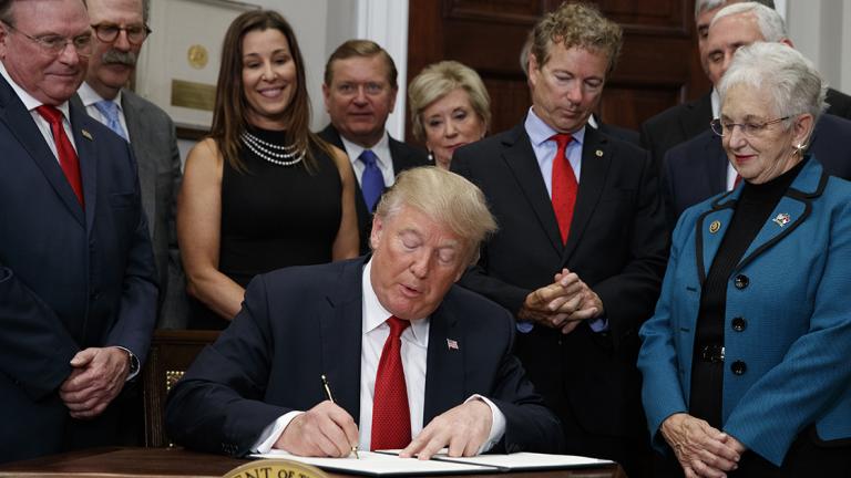 Donald Trump - President Donald Trump signs an executive order on health care in the Roosevelt Room of the White House, Thursday, Oct. 12, 2017, in Washington. (AP Photo/Evan Vucci)