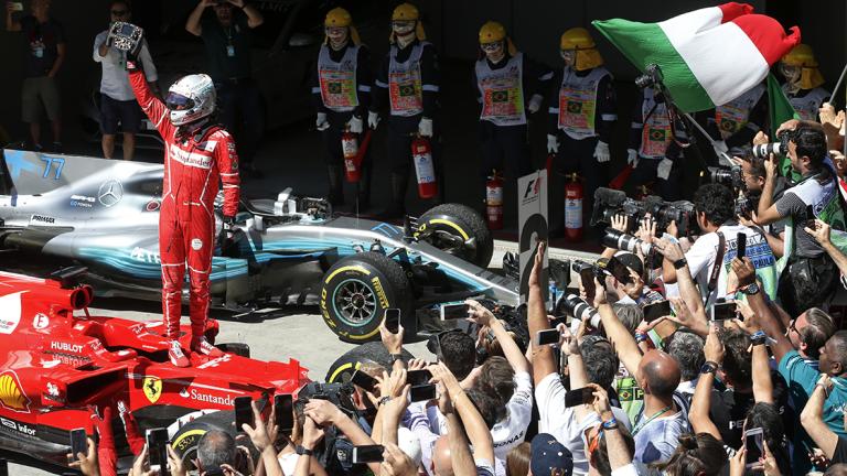 Ferrari driver Sebastian Vettel, of Germany, celebrates after winning the Brazilian Formula One Grand Prix at the Interlagos race track in Sao Paulo, Brazil, Sunday, Nov. 12, 2017. (AP Photo/Andre Penner)