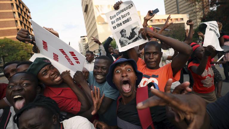 Zimbabweans celebrate after Mugabe resigns in Harare - Zimbabweans celebrate after President Robert Mugabe resigns in Harare, Zimbabwe November 21, 2017. REUTERS/Mike Hutchings