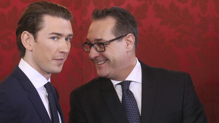 Newly sworn-in Austrian Chancellor Sebastian Kurz, left, and new Vice Chancellor Heinz-Christian Strache talk during the swearing-in ceremony of the new Austrian government led by a conservative and a nationalist party in Vienna, Austria, Monday, Dec. 18, 2017. (AP Photo/Ronald Zak)