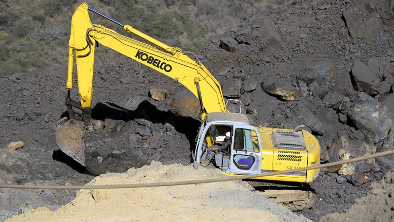 A backhoe is seen on a steel mine at the Aguililla community, in Michoacan State, Mexico, on February 14, 2014.  AFP PHOTO/ALFREDO ESTRELLA