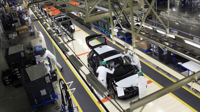 Employees work at a production line after the opening of Honda