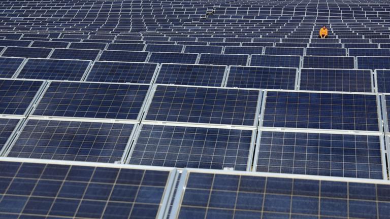 - - A maintenance man works on solar panels at Norsol solar energy company in Villaldemiro, northern Spain, on February 10, 2015. AFP PHOTO/ CESAR MANSO