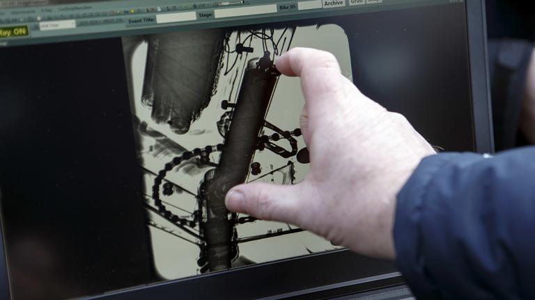 A UCI technician shows the detection of an engine in the frame of a bicycle scaned by a X-Ray machine, during a UCI