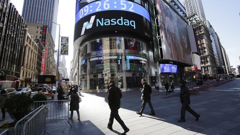 People walk past the Nasdaq MarketSite Tuesday, April 5, 2016, in New York. Stocks are opening broadly lower as investors reacted to a negative assessment of the global economy by the head of the International Monetary Fund. IMF chief Christine Lagarde warned in a speech today that the global recovery remains "too slow." (AP Photo/Mark Lennihan)