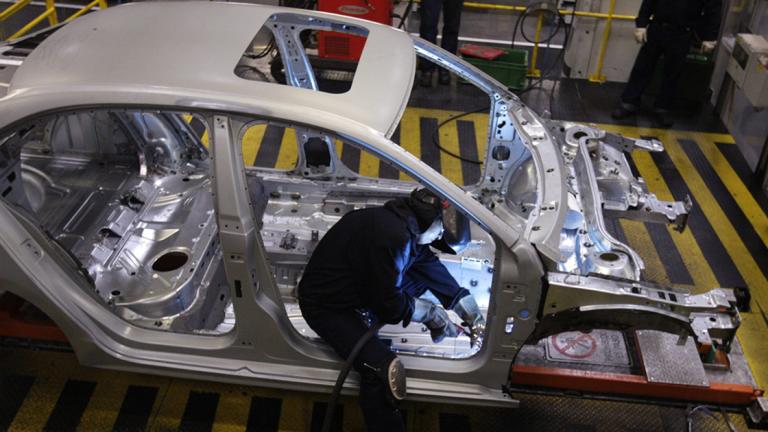 An employee works on the assembly line on the Jetta Bicentennial at the Volkswagen automobile manufacturing factory in Puebla - An employee works on the assembly line on the Jetta Bicentennial at the Volkswagen (VW) automobile manufacturing factory in Puebla August 12, 2010. Puebla, which will manufacture over half a million vehicles every year, is VW