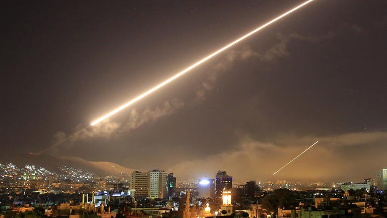 Damascus skies erupt with surface to air missile fire as the U.S. launches an attack on Syria targeting different parts of the Syrian capital Damascus, Syria, early Saturday, April 14, 2018. Syria