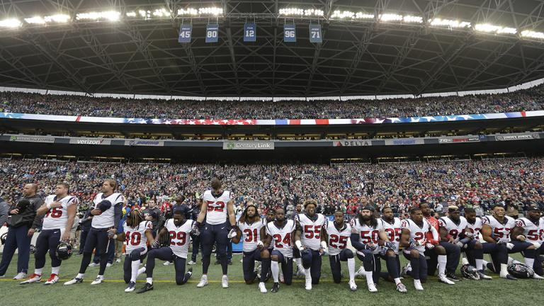 FILE - In this Oct. 29, 2017, file photo, Houston Texans players kneel and stand during the singing of the national anthem before an NFL football game against the Seattle Seahawks, in Seattle. NFL owners have approved a new policy aimed at addressing the firestorm over national anthem protests, permitting players to stay in the locker room during the "The Star-Spangled Banner" but requiring them to stand if they come to the field. The decision was announced Wednesday, May 23, 2018, by NFL Commissioner Roger Goodell during the league