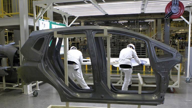 Employees work at a production line after the opening of Honda