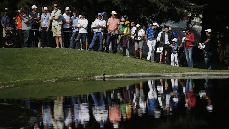 Spectators watch across a lake at the 6th hole, during round one of the Mexico Championship at Chapultepec Golf Club in Mexico City, Thursday, March 2, 2017. All but one of the world