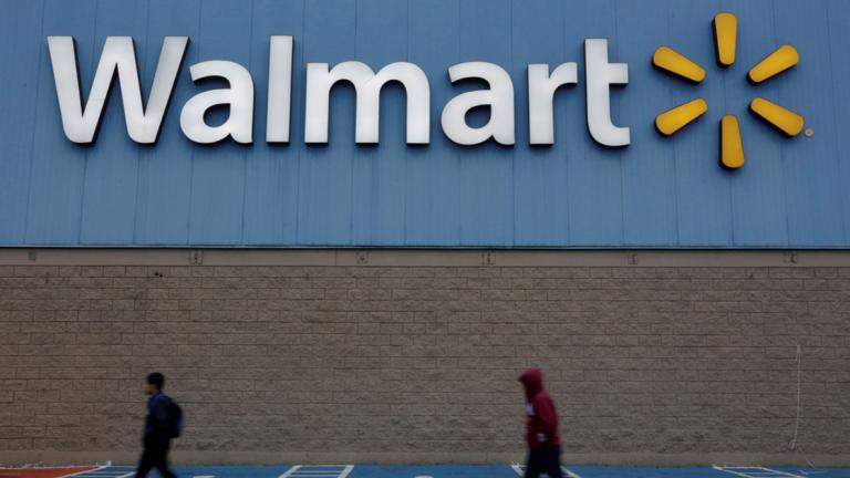 FILE PHOTO: Men walk past the logo of Walmart outside a store in Monterrey - FILE PHOTO: Men walk past the logo of Walmart outside a store in Monterrey, Mexico February 12, 2018. REUTERS/Daniel Becerril/File Photo - NARCH/NARCH30