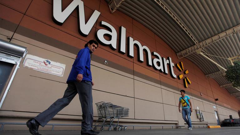 FILE PHOTO: Shoppers walk from a Wal-Mart store in Mexico City - FILE PHOTO: Shoppers walk from a Walmart store in Mexico City, August 15, 2012. REUTERS/Edgard Garrido/File Photo - NARCH/NARCH30