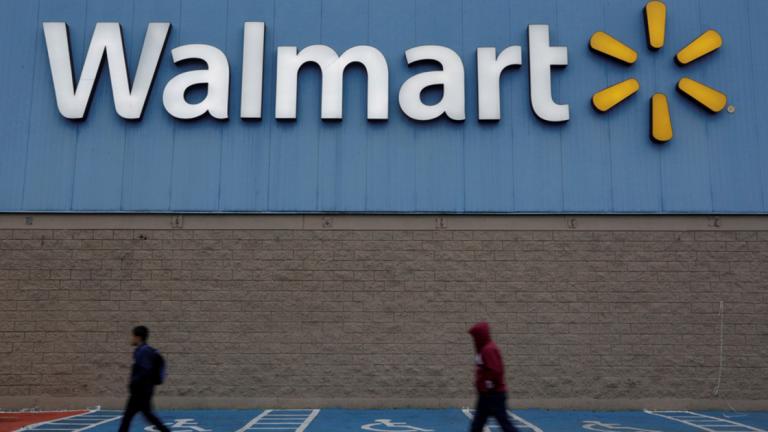 FILE PHOTO: Men walk past the logo of Walmart outside a store in Monterrey - FILE PHOTO: Men walk past the logo of Walmart outside a store in Monterrey, Mexico February 12, 2018. REUTERS/Daniel Becerril/File Photo - NARCH/NARCH30