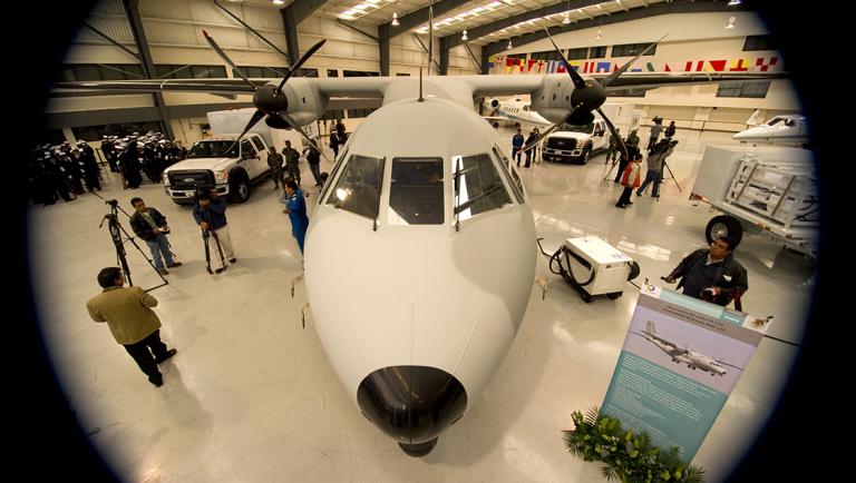 View of a Persuader CN-235 maritime surveillance aircraft and two Z Backscatter mobile screening vehicles delivered by the United States to Mexico under the Merida Initiative, in Mexico City on December 1, 2011. AFP PHOTO/Alfredo Estrella