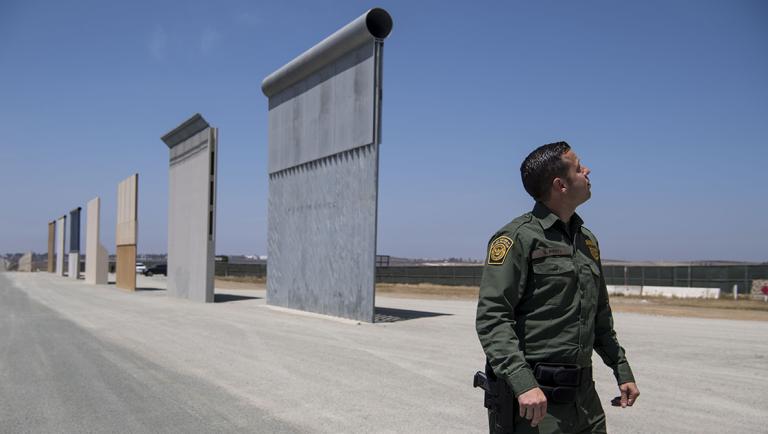 CALIF-BORDER - Border Patrol Public Affairs Officer Vincent Pirro looks at border wall prototypes in a sector of the border wall in San Diego, California, on April 25, 2018. MUST CREDIT: Washington Post photo by Carolyn Van Houten