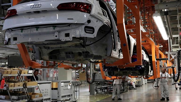 FILE PHOTO: Employees work at an Audi Q5 2.0 production line of the German car manufacturer