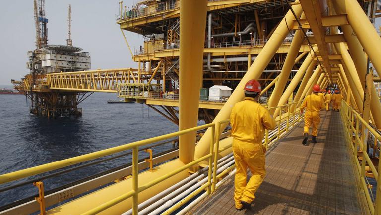 Employees walk on a bridge at the Mexico