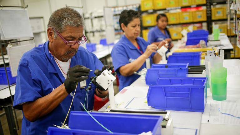 Employees work at Ark de Mexico, an assembly factory that makes wire harnesses and electric components for the automobile industry, in Ciudad Juarez