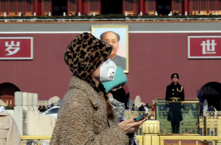 Tourists wearing masks visit Tiananmen Square in Beijing