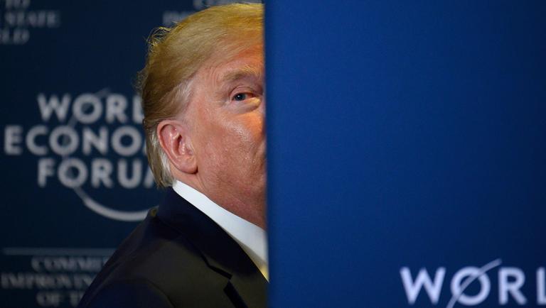 US President Donald Trump looks back as a question from the press is shouted after a press conference at the World Economic Forum in Davos, Switzerland, on January 22, 2020. (Photo by JIM WATSON / AFP)