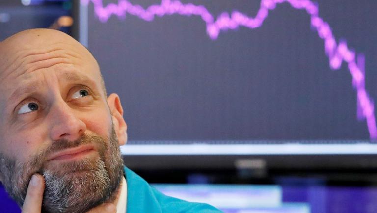 A trader reacts as he works on the floor of the New York Stock Exchange (NYSE) in New York City