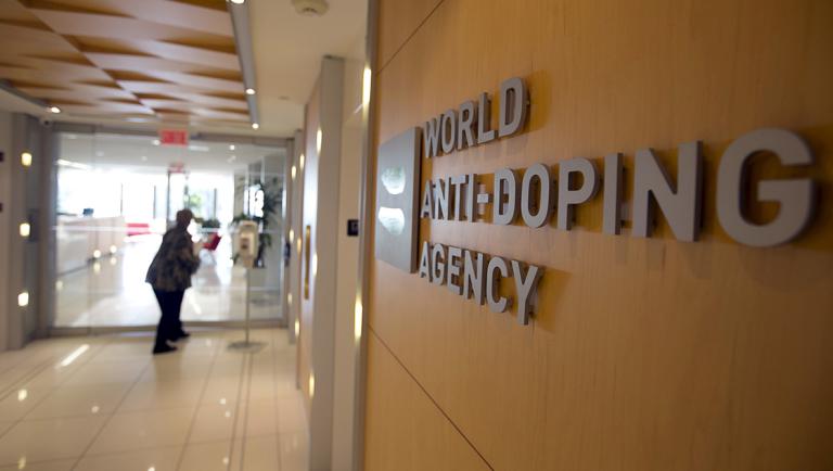 A woman walks into the head offices of WADA in Montreal