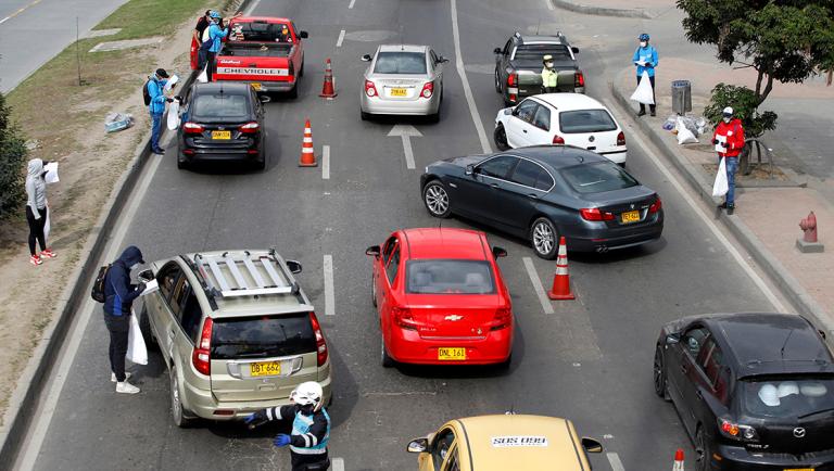 Cars are stopped on a highway by city officials hours before the Colombian government