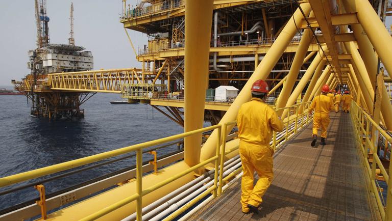 Employees walk on a bridge at the Mexico