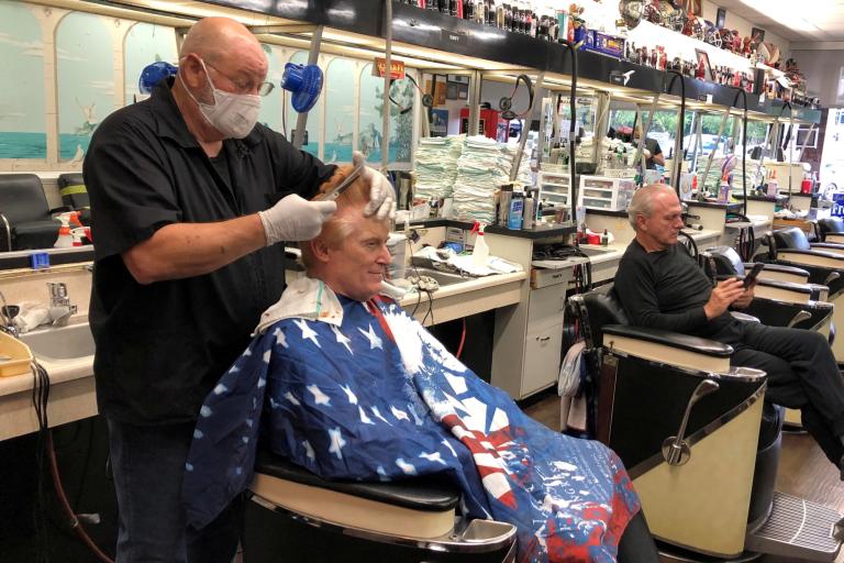 Barber Tommy Thomas gives his long-time customer Fred Bentley a haircut in Atlanta