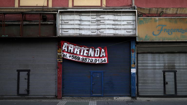 A closed store with a sign that reads "Rented by owner" in a commercial sector of Santiago, during a preventive quarantine after the outbreak of coronavirus disease (COVID-19), in Santiago