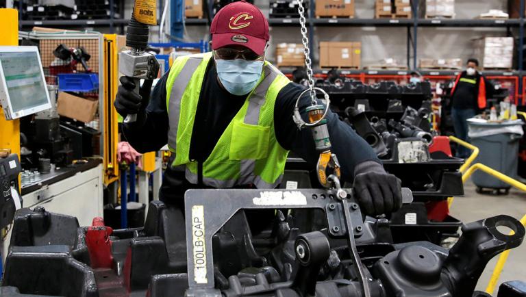 Dana Inc. assembly technician Brandon Green wears a face mask as he works to assemble axles for automakers, amid the coronavirus disease (COVID-19) outbreak, in Toledo