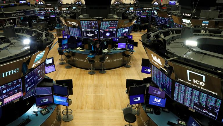 FILE PHOTO: Floor traders work space is seen on the trading floor after the closing bell, following traders positive for Coronavirus disease (COVID-19), at the NYSE in New York