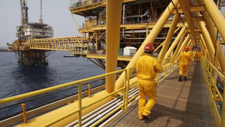 Employees walk on a bridge at the Mexico