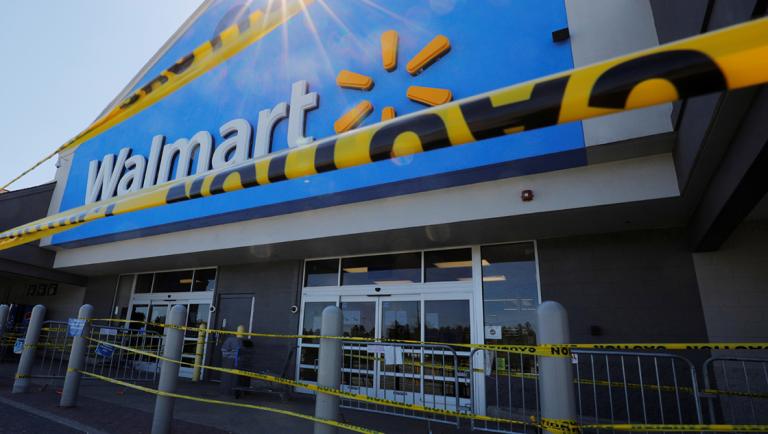 Caution tape hangs at the entrance of a temporarily closed Walmart store, where a number of employees tested positive for the coronavirus disease (COVID-19) and one employee died, in Quincy, Massachusetts, U.S., May 5, 2020.   REUTERS/Brian Snyder