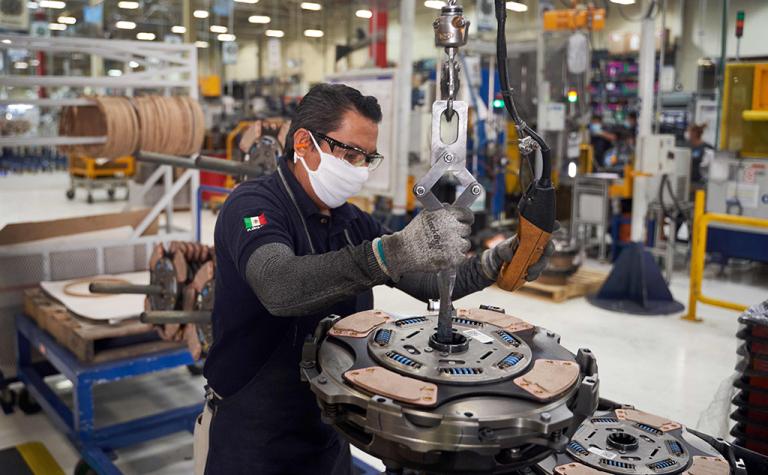 A worker resumes activities at a truck part factory after it was closed for several weeks to prevent the spread of coronavirus in San Luis Potosi, Mexico on May 27, 2020. (Photo by MAURICIO PALOS / AFP)