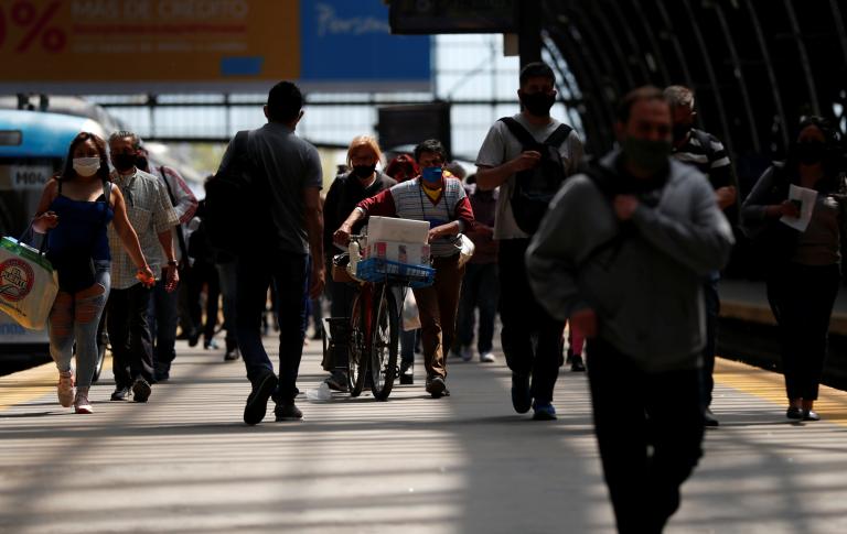 Commuters walk along a platform at Retiro train station, during the spread of the coronavirus disease (COVID-19), in Buenos Aires