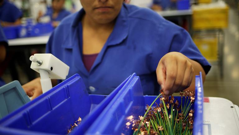 An employee works at Ark de Mexico, an assembly factory that makes wire harnesses and electric components for the automobile industry, in Ciudad Juarez