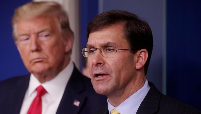 FILE PHOTO: U.S. President Trump listens to Secretary of Defense Mark Esper speak about coronavirus response at the White House in Washington