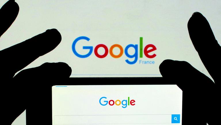 FILE PHOTO: A woman holds her smart phone which displays the Google home page, in this picture illustration taken February 24, 2016. REUTERS/Eric Gaillard/Illustration/File Photo-NARCH/NARCH30 NARCH/NARCH30