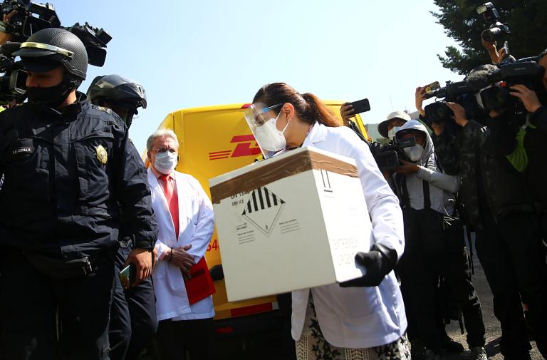 A medical staff member holds a box while simulating to carry the COVID-19 vaccine during a drill  days before starting the vaccination process from the Pfizer-BioNTech COVID-19 vaccine, in Mexico City