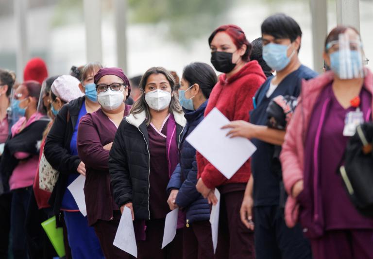 Medical workers line up to receive an injection with a dose of the Pfizer-BioNTech COVID-19 vaccine at the Regional Military Specialty Hospital in San Nicolas de los Garza