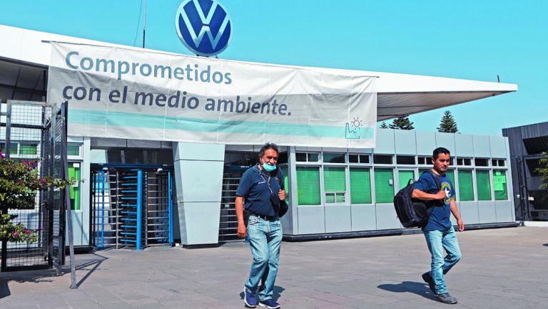 FILE PHOTO: Employees leave the Volkswagen (VW) plant as the company will temporarily close its factories in Mexico amid growing worries over the spread of the coronavirus disease (COVID-19), in Puebla