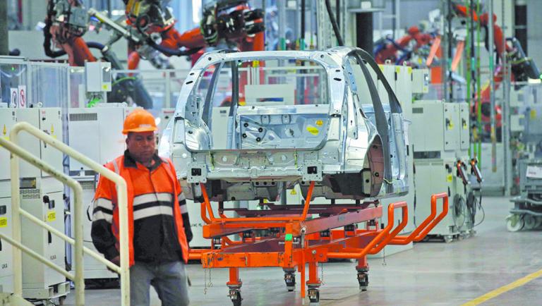 An employee walks past at an Audi Q5 2.0 production line of the German car manufacturer's plant during a media tour in San Jose Chilapa, Mexico April 19, 2018. REUTERS/Henry Romero