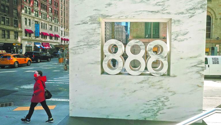 A person walks past 888 7th Ave, a building that reportedly houses Archegos Capital in New York City